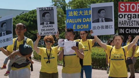 Members of the Portuguese chapter of Falun Gong demonstrate outside Belem Palace on July 12, 2017 in Lisbon, Portugal. (Photo by Horacio Villalobos/Corbis via Getty Images)