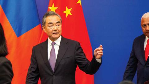 Chinese Foreign Minister Wang Yi leaves after a joint press conference with Fijian Prime Minister Frank Bainimarama in Fiji's capital city Suva. (Photo by Leon Lord/AFP via Getty Images)