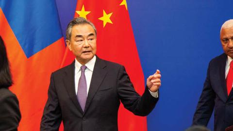 Chinese Foreign Minister Wang Yi leaves after a joint press conference with Fijian Prime Minister Frank Bainimarama in Fiji's capital city Suva. (Photo by Leon Lord/AFP via Getty Images)