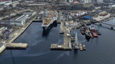 Russian Navyâs lone aircraft carrier, the Admiral Flota Sovetskogo Soyuza Kuznetsov, is towed to the 35th squadron shipyard for maintenance and repair works in Murmansk, Russia on May 20, 2022. (Photo by Semen Vasileyev/Anadolu Agency via Getty Images)