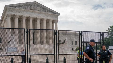 Law enforcement guard the front of the Supreme Court on June 14, 2022 in Washington, DC. (Photo by Nathan Howard/Getty Images)