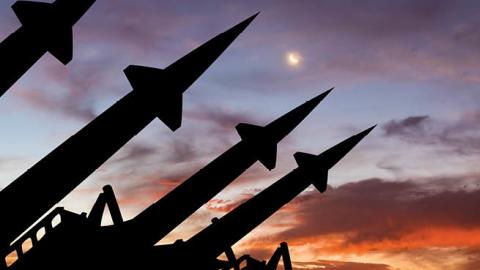 Silhouette on missile system against sunset. (Anton Petrus via Getty Images)