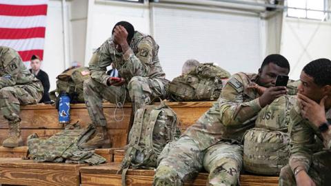 U.S. service members wait at the Pope Army Airfield before deploying to Europe at Fort Bragg, North Carolina, on February 3, 2022. (Allison Joyce/AFP via Getty Images)