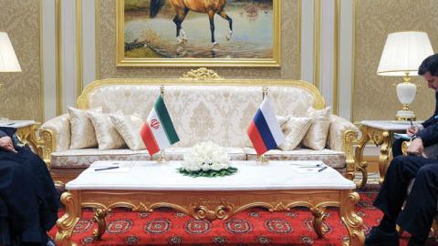 Russian President Vladimir Putin speaks with Iran's President Ebrahim Raisi during their meeting on the sidelines of the 6th Caspian Summit in Ashgabat on June 29, 2022. (Photo by Mikhail Klimentyev/SPUTNIK / AFP via Getty Images)