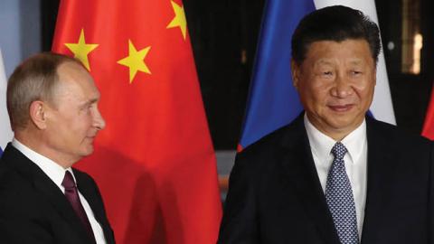 Russian President Vladimir Putin shakes hands with Chinese Leader Xi Jinping during a meeting in Xiamen, China, on September 3, 2017. (Photo by Mikhail Svetlov/Getty Images)