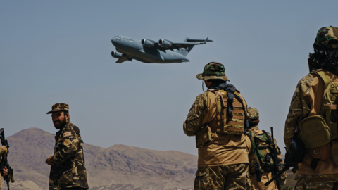 A C-17 Globemaster takes off as Taliban fighters secure the outer perimeter alongside the American controlled side of of the Hamid Karzai International Airport in Kabul, Afghanistan, on Sunday, Aug. 29, 2021. (Marcus Yam / Los Angeles Times)