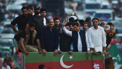 Former Pakistani Prime Minister Imran Khan waves to supporters in Rawalpindi, Pakistan, on July 2, 2022, during a protest rally against inflation, political destabilization, and hikes in fuel prices. (Photo by Farpq Naeem/AFP via Getty Images)