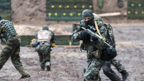 Members of the Ukrainian Territorial Defense Forces participate in tactical exercises in the forest near Kyiv, Ukraine, on July 13, 2022. (Maxym Marusenko/NurPhoto via Getty Images)