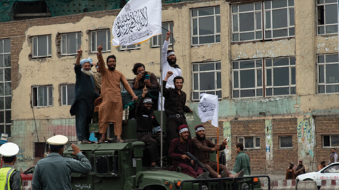 Taliban members ride on top of an armored vehicle on August 15, 2022, during a celebration of the first anniversary of the Taliban's return to power in Kabul, Afghanistan. (Nava Jamshidi/Getty Images)