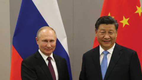Russian President Vladimir Putin greets Chinese President Xi Jinping during their bilateral meeting on November 13, 2019, in Brasilia, Brazil. (Mikhail Svetlov/Getty Images)