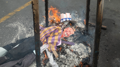 Iranian demonstrators burn an effigy of President Joe Biden in downtown Tehran during a rally commemorating the International Quds Day on April 29, 2022. (Morteza Nikoubazl/NurPhoto via Getty Images)