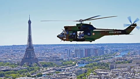 A French army Puma helicopter flies over the Eiffel Tower during an aerial rehearsal parade before Bastille Day on July 11, 2022, in Paris, France. (Photo by Aurelien Meunier/Getty Images)