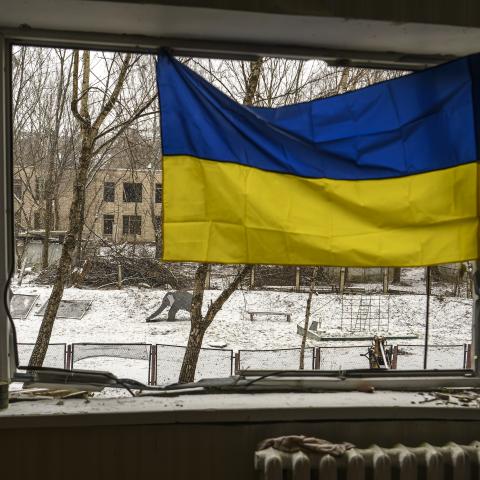 A Ukrainian flag is hanging in the window of an apartment building that has been heavily damaged during Russia's massive rocket attack on Kyiv, in Kyiv, Ukraine, on January 3, 2024. (Maxym Marusenko/NurPhoto via Getty Images)