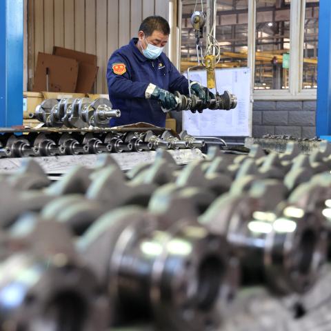 A quality inspector checks crankshafts at a factory that produces the mechanical component for the domestic market and export in Binzhou, China, on December 10, 2024. (Getty Images)