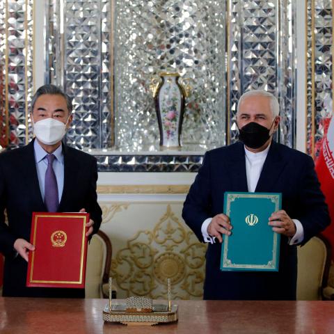 Iranian Foreign Minister Mohammad Javad Zarif and Chinese Foreign Minister Wang Yi pose for a picture after signing a 25-year strategic cooperation pact on March 27, 2021. (Getty Images)