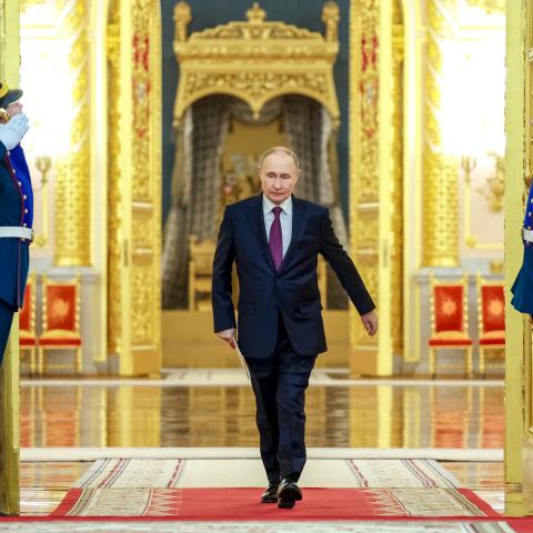 In this pool photograph distributed by the Russian state agency Sputnik, Vladimir Putin enters a hall to meet with graduates of higher military educational institutions at the Kremlin on June 23, 2025. (Alexander Kazakov via Getty Images)