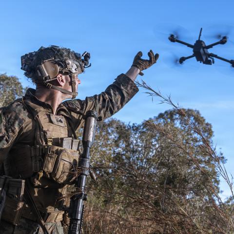An intelligence specialist activates a Skydio X2 small unmanned aerial system to survey the defensive line for opposing forces during a simulated assault and seizure at Glen Airfield in Queensland, Australia, in July 2025. (US Marine Corps)
