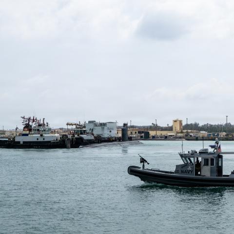  Los Angeles-class fast-attack submarine USS Jefferson City (SSN 759) and a harbor patrol boat transits Apra Harbor at Naval Base Guam, April 20, 2026. Assigned to Commander, Submarine Squadron 15 at Polaris Point, Naval Base Guam, Jefferson City is one of five fast-attack submarines forward-deployed in the Pacific. Renowned for their unparalleled speed, endurance, stealth, and mobility, fast-attack submarines serve as the backbone of the Navy's submarine force, ensuring readiness and agility in safeguardin