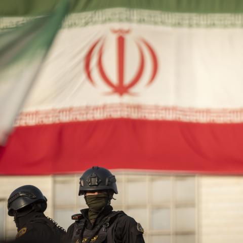 Armed members of Iran's police special forces monitor an area while standing on an armored military vehicle under a country flag during a pro-Government rally in downtown Tehran, Iran, on January 12, 2026. The rally is held in Tehran against the recent anti-government unrest, opposition to the U.S. and Israel in Iran, and in support of Supreme Leader Ayatollah Ali Khamenei. (Photo by Morteza Nikoubazl/NurPhoto via Getty Images)