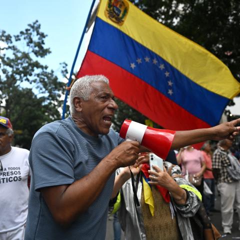 A demonstrator takes part in a protest outside the Melia Caracas Hotel in Caracas, Venezuela, on August 12, 2026. (Getty Images)