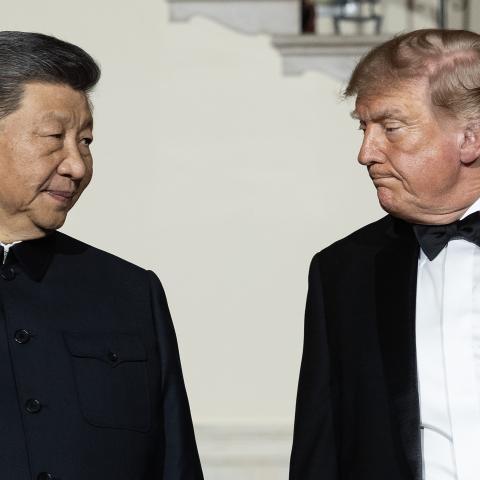 Chinese President Xi Jinping looks to US President Donald Trump as they descend the grand staircase before a state dinner in the East Room of the White House on September 24, 2026, in Washington, DC. (Getty Images)