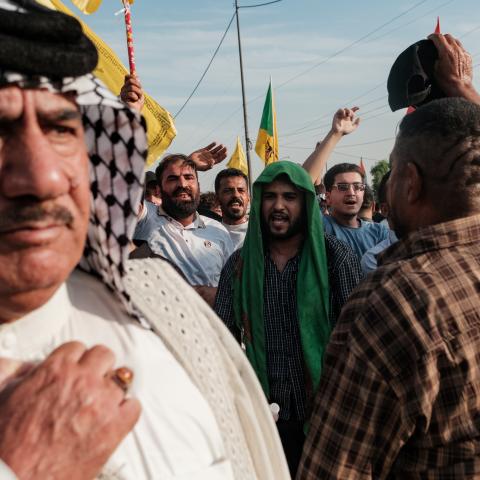 Supporters of the Popular Mobilisation Forces (PMF) chant slogans and wave flags at a rally celebrating the end of the US military presence in Iraq on September 30, 2026, in Baghdad, Iraq. (Getty Images)