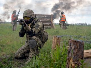 A soldier aims a rifle during a military drill in Kyiv Region, Ukraine. (Ukrinform via Getty Images)