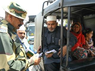 An Indian Border Security Force soldier checks the passports of Pakistani citizens as they return to their country at the India-Pakistan border on the outskirts of Amritsar, India, on April 25, 2025. (Narinder Nanu via Getty Images)