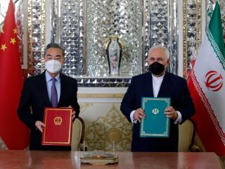 Iranian Foreign Minister Mohammad Javad Zarif and Chinese Foreign Minister Wang Yi pose for a picture after signing a 25-year strategic cooperation pact on March 27, 2021. (Getty Images)