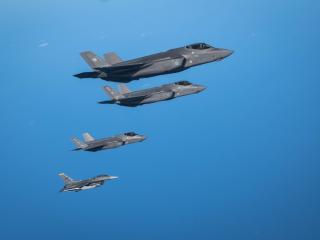 A Japan Air Self-Defense Force F-35A Lightning II flies alongside two F-35A Lightning IIs and an F-16 Fighting Falcon of the US Air Force over the Pacific Ocean near Misawa Air Base in Japan on September 30, 2025. (US Air Force)