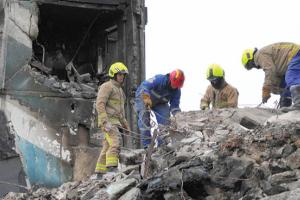 Firefighters remove rubble at a destroyed apartment building on April 10, 2022, in Borodyanka, Ukraine. (Getty Images)