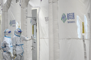 Staff members work at Dian rapid mobile diagnostics laboratory for COVID-19 testing on January 27, 2022, in Hangzhou, China. (Photo by VCG via Getty Images)