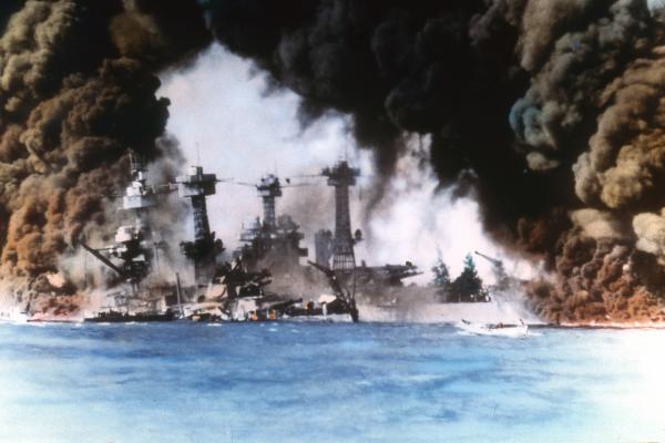 Thick smoke billows up from stricken American warships (from left, USS West Virginia and USS Tennessee) along battleship row during the Japanese attack on Pearl Harbor, Honolulu, Oahu, Hawaii, December 7, 1941. (Photo by US Navy/Interim Archives/Getty Images)