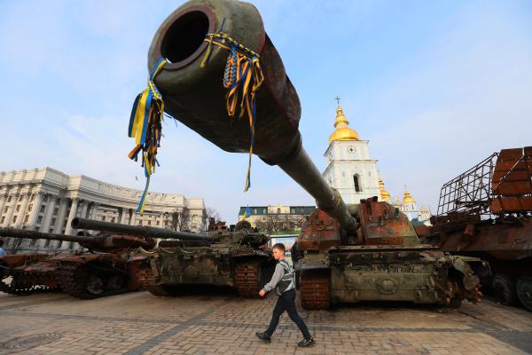 A boy walks past of a street exhibition of destroyed Russian military vehicles in center of Kyiv, Ukraine 21 March 2023. (Photo by STR/NurPhoto via Getty Images)