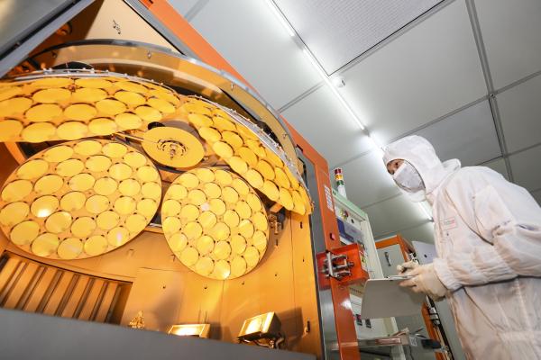 An employee works on the production line of LED epitaxial wafer on March 25, 2022, in Jiangsu Province, China. (Zhao Qirui/VCG via Getty Images)