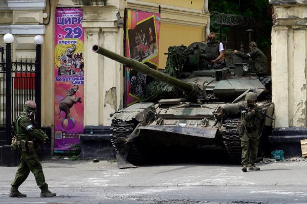  Members of Wagner patrol in an area near a tank outside a circus building in the city of Rostov-on-Don, Russia, on June 24, 2023. (Photo by STRINGER/AFP via Getty Images)
