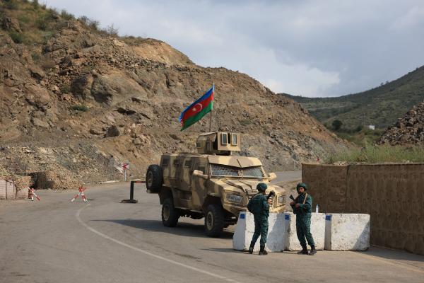 Azerbaijani servicemen stand guard at the Lachin checkpoint on October 1, 2023. (Photo by Emmanuel Dunand/AFP via Getty Images)
