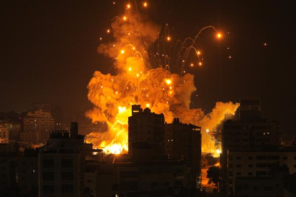 A missile explodes in Gaza City during an Israeli air strike on October 8, 2023. (Photo by MAHMUD HAMS/AFP via Getty Images)