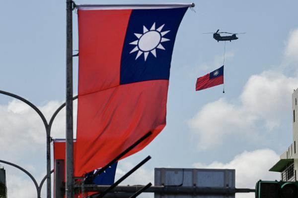 A CH-47 Chinook helicopter carries a Taiwan flag during National Day celebrations in Taipei on October 10, 2021. (Sam Yeh/AFP via Getty Images)