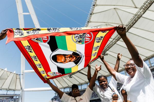 Inkatha Freedom Party (IFP) supporters hold a flag depicting former IFP leader Mangosuthu Buthelezi in Durban, South Africa, on March 10, 2024. (Photo by Rajesh Jantilal/AFP via Getty Images)