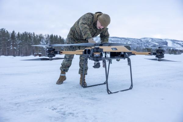 U.S. Marine Corps Lance Cpl. Andrew Hill, a motor transport operator assigned to Combat logistics Battalion 6, Combat Logistics Regiment 2, 2nd Marine Logistics Group, fastens the propeller arms on a Tactical Resupply Vehicle 150 (TRV) unmanned aircraft system during test flight operations in Setermoen, Norway, Feb. 6, 2024.   (U.S. Marine Corps photo by Lance Cpl. Christian Salazar)