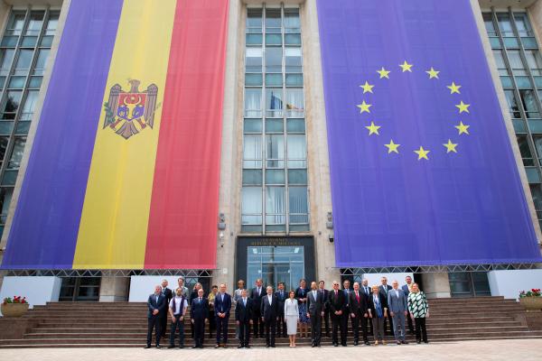 Moldovan President Maia Sandu and European Union Commissioner for Budget and Administration Johannes Hahn pose in front of the Moldovan and EU flags in Chisinau, Moldova, on May 9, 2024. (Elena Covalenco via Getty Images)