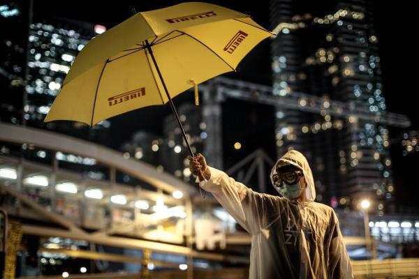 A pro-democracy activists stands with a yellow umbrella as part of an art installation outside Hong Kong's Government complex on October 9, 2014. (Photo by Chris McGrath/Getty Images)