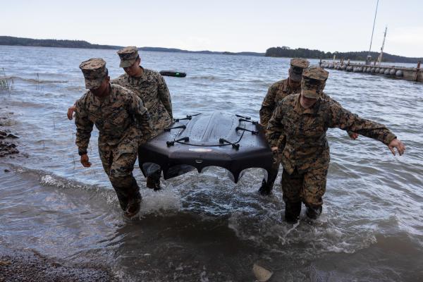 US marines carry a general purpose high speed uncrewed surface vehicle, known as the Reckless, during exercise Baltic Operations 24 at Camp Berga, Sweden, on June 12, 2024. (US Marine Corps photo)