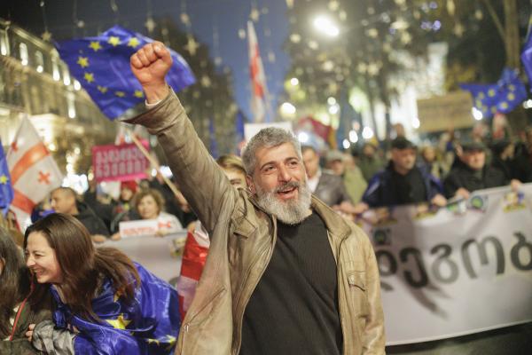 Tbilisi residents protest after the Georgian Dream government announced a suspension of negotiations on EU candidate status until 2028, as police detain demonstrators during a crackdown in the capital on November 28, 2025. (Photo by Sebastien Canaud/NurPhoto via Getty Images)