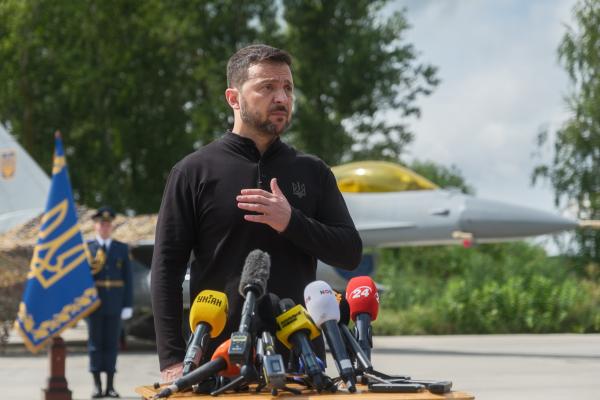 President of Ukraine Volodymyr Zelenskyi stands in front of the first General Dynamics F-16 Fighting Falcon received by Ukraine as he congratulates Ukrainian military on the Day of Ukrainian Air Force on August 4, 2024 in Unspecified, Ukraine. At the event for the Day of Ukrainian Air Force with the participation of President of Ukraine Volodymyr Zelenskyi, the first General Dynamics F-16 Fighting Falcons received by Ukraine were demonstrated. (Photo by Vitalii Nosach/Global Images Ukraine via Getty Images)