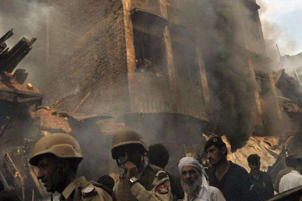 A Pakistani security serviceman is pictured amid bodied and wreckage at the scene of a bomb explosion in Quetta on March 14, 2014. (BANARAS KHAN/AFP/Getty Images)