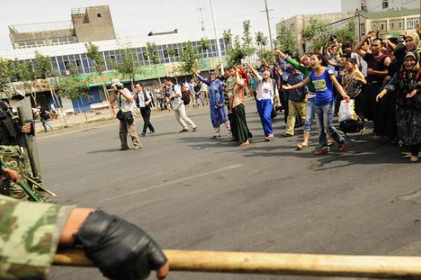 Ethnic Uyghur women protest towards Chinese riot police in Urumqi in China's far west Xinjiang province on July 7, 2009. (PETER PARKS/AFP/Getty Images)