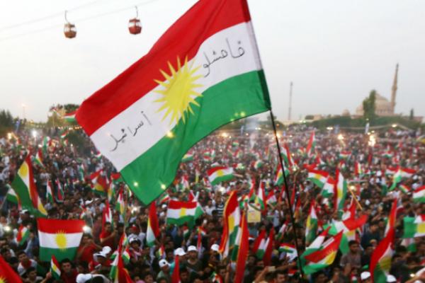 Iraqi Kurds fly Kurdish flags during an event to urge people to vote in the upcoming independence referendum, September 16, 2017 (SAFIN HAMED/AFP/Getty Images)