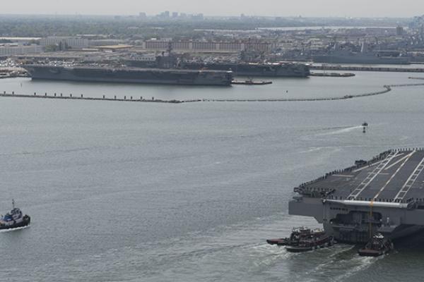 USS Gerald R. Ford (CVN 78) arriving at Naval Station Norfolk in Virginia approaching its berth next to the Nimitz-class aircraft carriers USS Dwight D. Eisenhower (CVN 69) and USS George Washington (CVN 73)